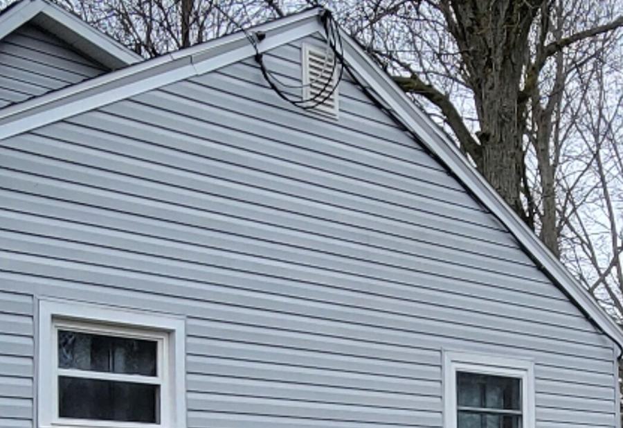 Gable siding with algae streaks washed clean — after