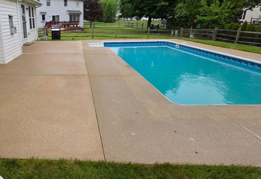 Pool deck concrete scrubbed free of algae streaks and stains — after