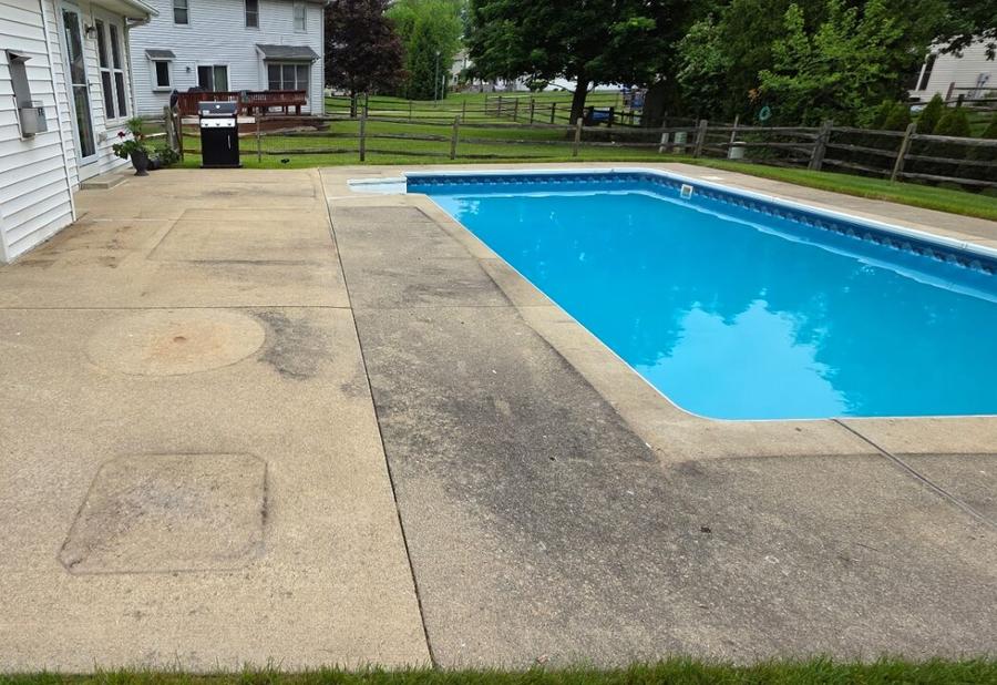 Pool deck concrete scrubbed free of algae streaks and stains — before